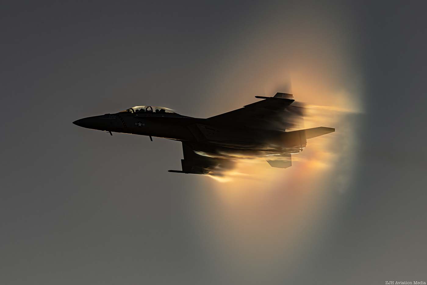 F/A-18 Super Hornet side view silhouette in a sunset blue sky